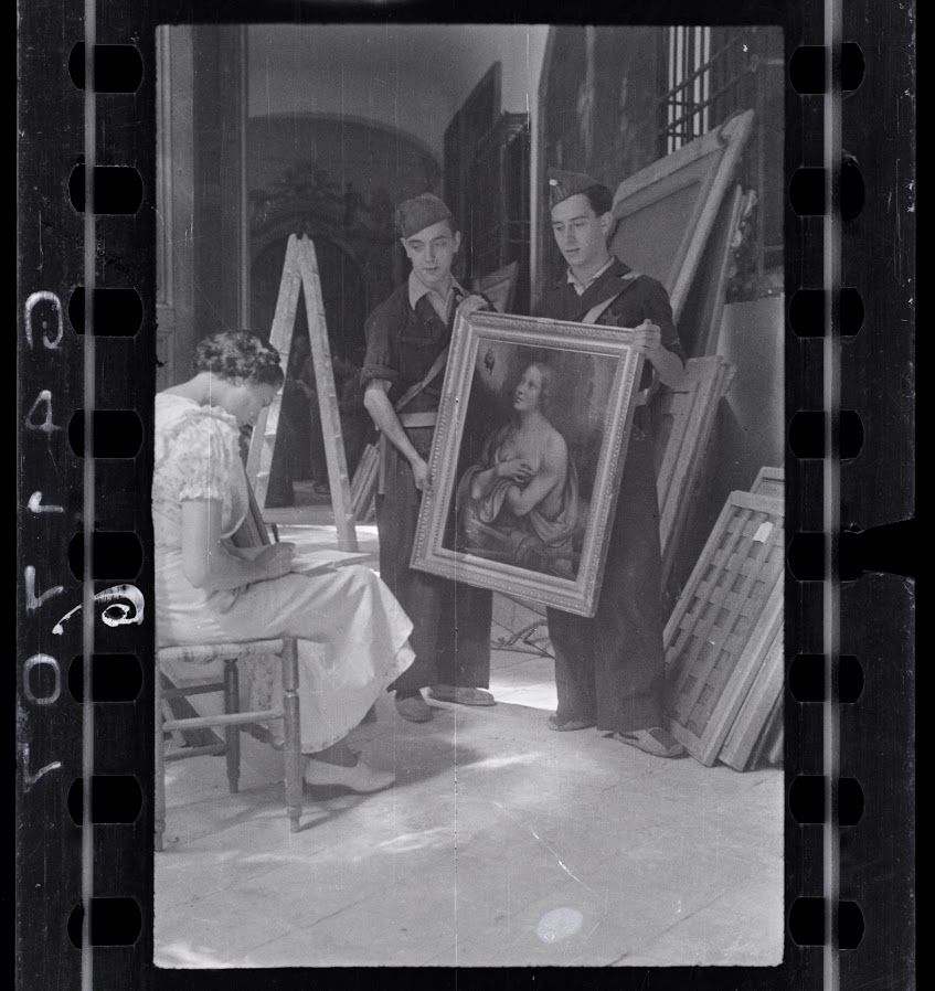 Mulher fazendo inventário de pinturas na coleção do convento de Las Descalzas Reales com dois soldados republicanos , Madrid, outubro - novembro de 1936. Fotografia de Chim (David Seymour)